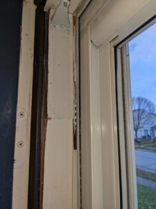 Close-up of a severely water-damaged door frame requiring repair by Home Care & Repair specialists in Lafayette, IN.