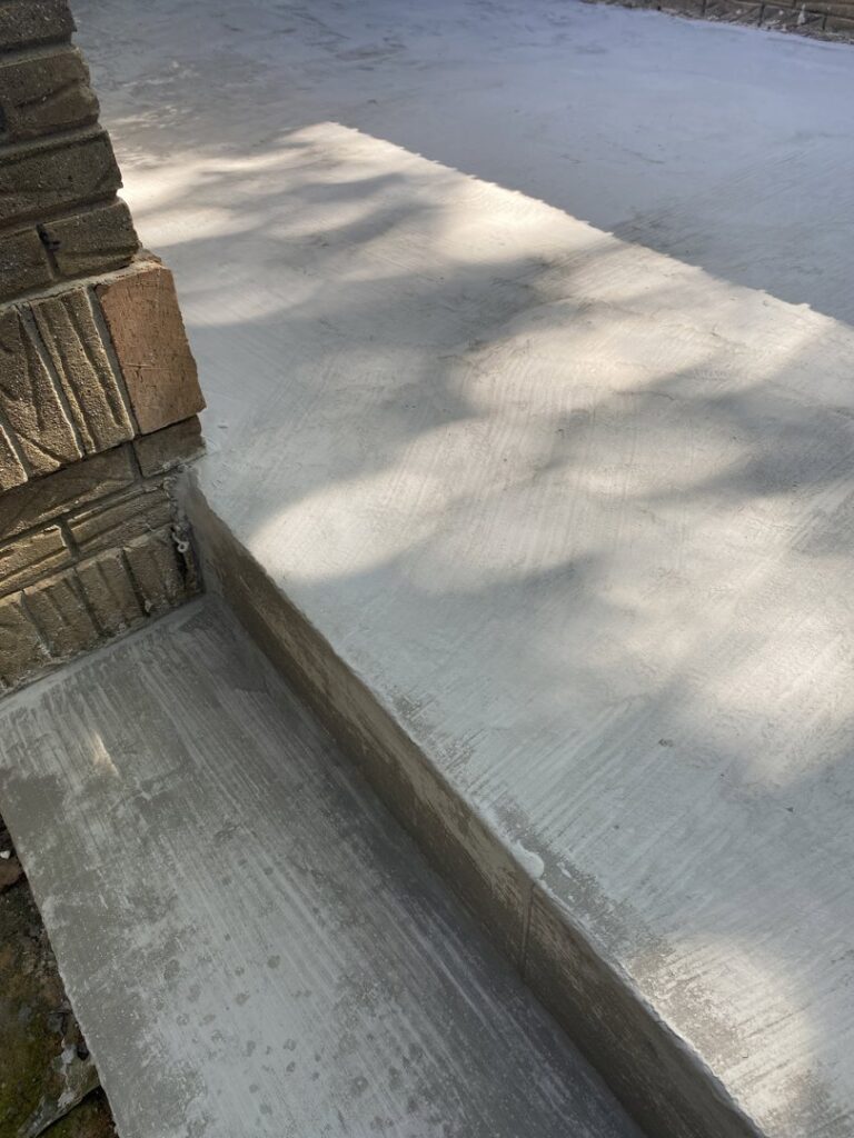 A close-up of a damaged wooden doorway threshold, indicating potential water damage, addressed by HNO Waterproofing & Slab Lifting Pros in Concord, NC.