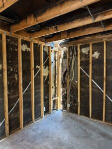 Damaged exposed framing and ceiling joists, showing signs of water damage, by Western Skies Restoration in Gilbert, AZ.