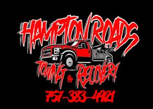 A damaged grey sedan on a flatbed tow truck, towing another dark sedan behind it by Hampton Roads Towing Services in Chesapeake, VA.