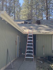 A house with a damaged roof and missing shingles, indicating a need for restoration services from Central Oregon Disaster Restoration in Bend, OR.