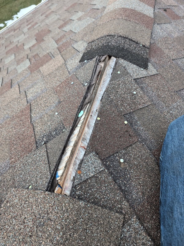 Damaged roof shingles and exposed underlayment needing repair by Exterior Repair Medics in Manhattan, KS.