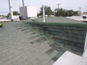 A damaged shingle roof with discoloration and missing shingles, indicating a need for water damage repair by DryTech in El Paso, TX.