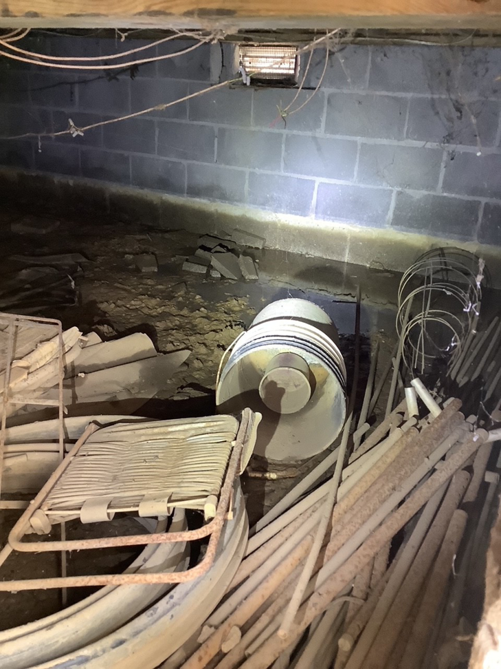 A damp crawlspace showing water damage and moisture on concrete walls, addressed by Allied Foundation & Crawlspace Solutions in Decatur, AL.