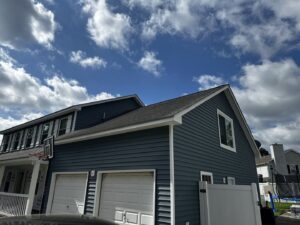 A modern home showcasing a fresh dark blue siding installation by Cordell Exteriors Inc in Chesapeake, VA