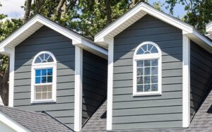 A residential home featuring dark gray horizontal and shake siding installed by Bushco Contracting LLC in Fresno, CA.