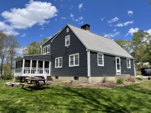 A residential home showcasing new dark gray horizontal siding installed by Atlantic Roofing and Siding in East Hartford, CT.
