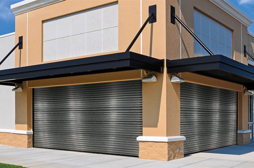 Two dark gray rolling steel commercial garage doors installed on the exterior of a building by Wayne Dalton Sales & Service of Quad Cities in Davenport, IA.