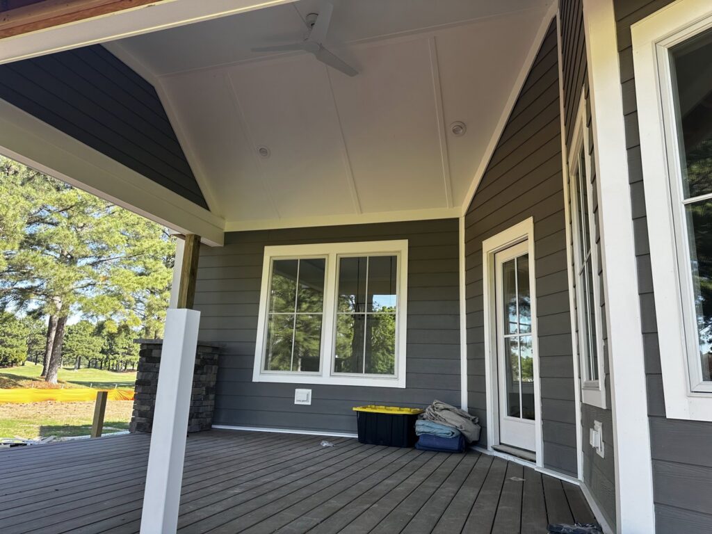 A home with dark gray siding and a spacious deck completed by Cordell Exteriors Inc in Chesapeake, VA