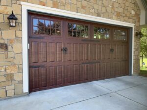 Beautiful dark wood-look garage door with decorative hardware installed by Garage Door Store Boise, ID.