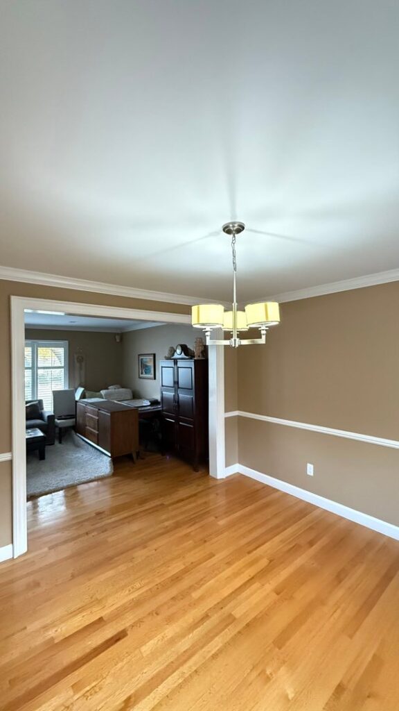A water damage specialist removing debris and drying exposed wooden structures in a water-damaged bathroom for H2O Pros Water Restoration Services in Westland, MI.