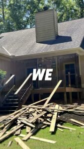 A large pile of wooden deck demolition debris on a residential lawn, showcasing debris removal services by Duffield Construction Group in Columbus, GA.