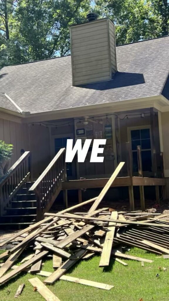 A large pile of wooden deck demolition debris on a residential lawn, showcasing debris removal services by Duffield Construction Group in Columbus, GA.