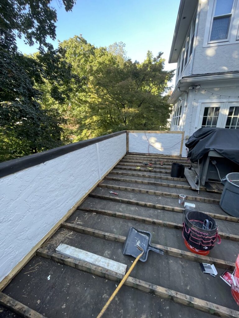 A deck undergoing waterproofing and repair, showing the exposed membrane and framing by Peach3 Group in New Rochelle, NY.