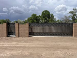 A newly installed decorative metal gate with brick pillars by Excellence Garage DOORS LLC in Los Angeles, CA
