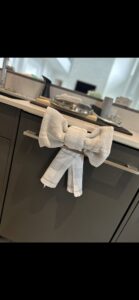 A decorative towel tied in a bow on a kitchen cabinet handle, a detail from We Maid It Two Cleaning Services LLC in Owensboro, KY.