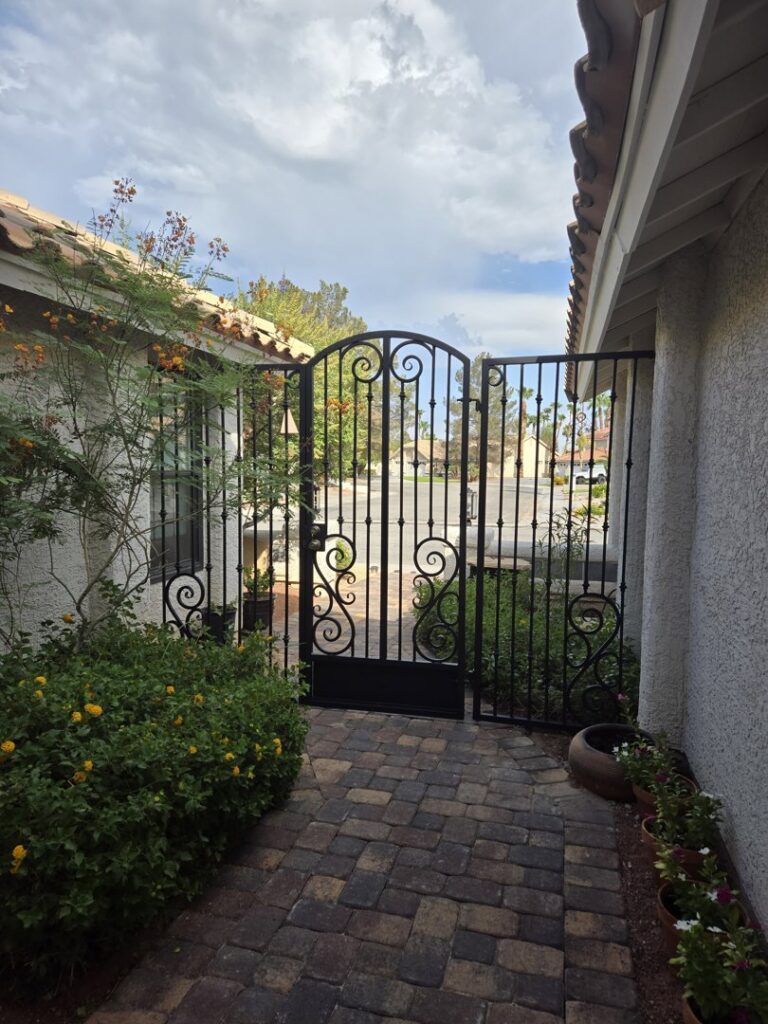 A decorative wrought iron courtyard gate installed by Giddy Up Garage Doors & Iron in Las Vegas, NV.