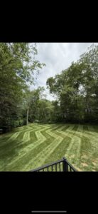A lawn expertly mowed in a decorative zigzag pattern, a signature service from A & J Lawn Care LLC in Seaford, DE.