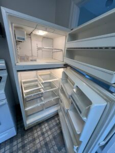 An immaculately deep-cleaned and empty refrigerator, showcasing the work of Best Bay Area Cleaners in Oakland, CA.