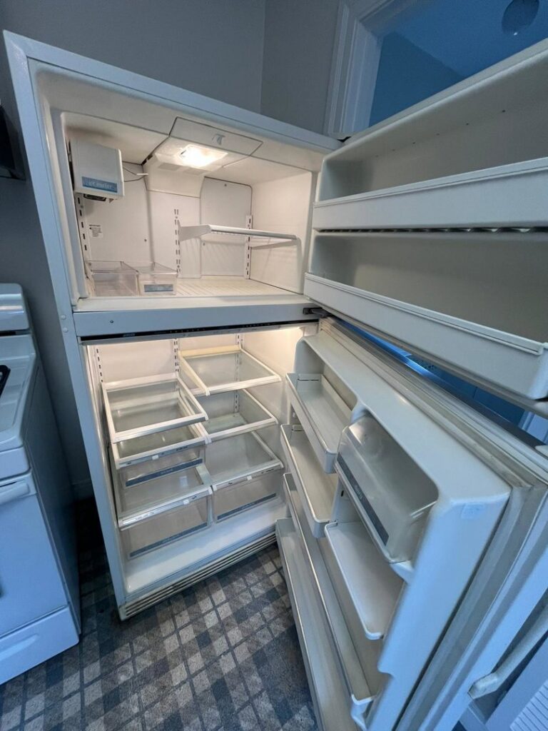 An immaculately deep-cleaned and empty refrigerator, showcasing the work of Best Bay Area Cleaners in Oakland, CA.