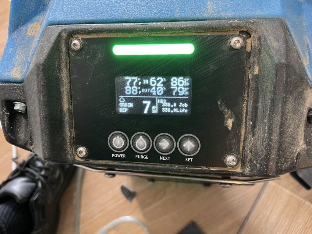 Close-up of a dehumidifier display showing humidity levels during water damage restoration by Prime Restoration in Lancaster, PA.