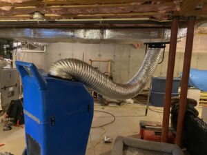 A large industrial dehumidifier with ductwork used for water damage restoration by Adams Emergency One in East Providence, RI