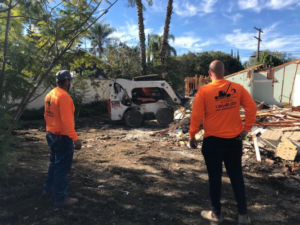 A demolition crew with a bobcat on a residential demolition site for DEMO Leaders in Los Angeles, CA
