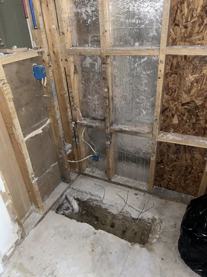 Demolition work in progress for water damage repair, showing exposed studs and removed flooring by Coastal Site Services in Bluffton, SC.