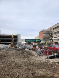 A demolition site featuring heavy machinery and debris, managed by DeCarlo Demolition Company in Des Moines, IA.