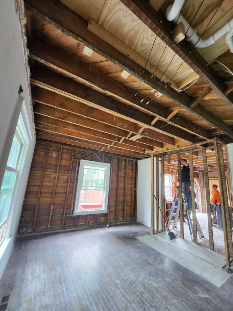 Demolition workers on ladders removing interior structures for Allis Demolition & Hauling LLC in Omaha, NE