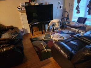 A dining room with cleaning supplies on the table, showing a house cleaning job by Shine Cleaning Service, LLC in Manchester, CT.