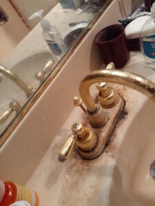 A close-up of a dirty bathroom faucet with hard water stains and grime, ready for cleaning by L & G Cleaning Service in Aurora, CO.