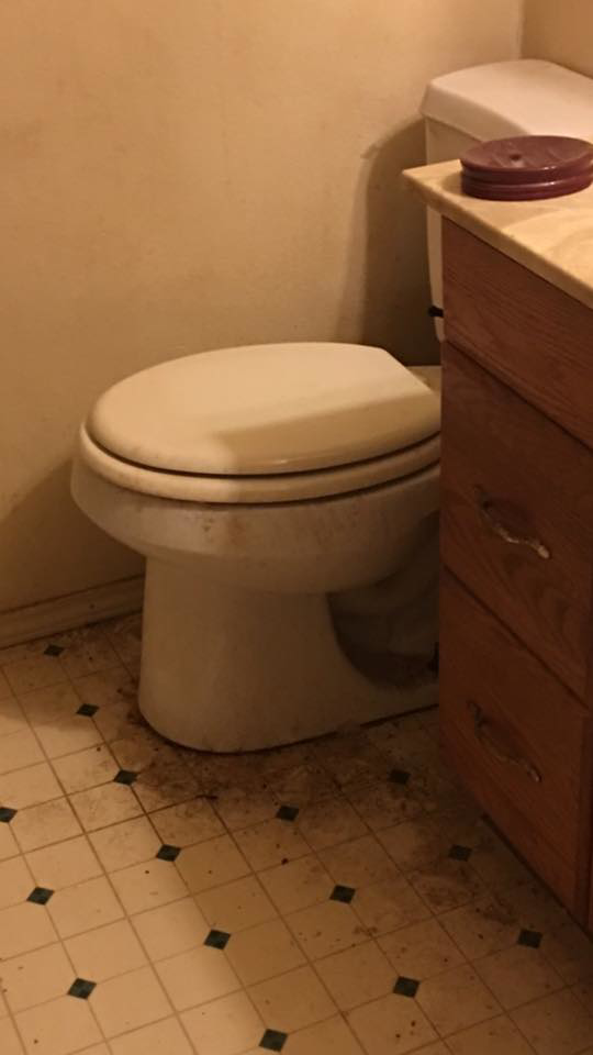 A very dirty bathroom floor and toilet area in a home, showing a need for Precision Residential Cleaning in Dallas, TX