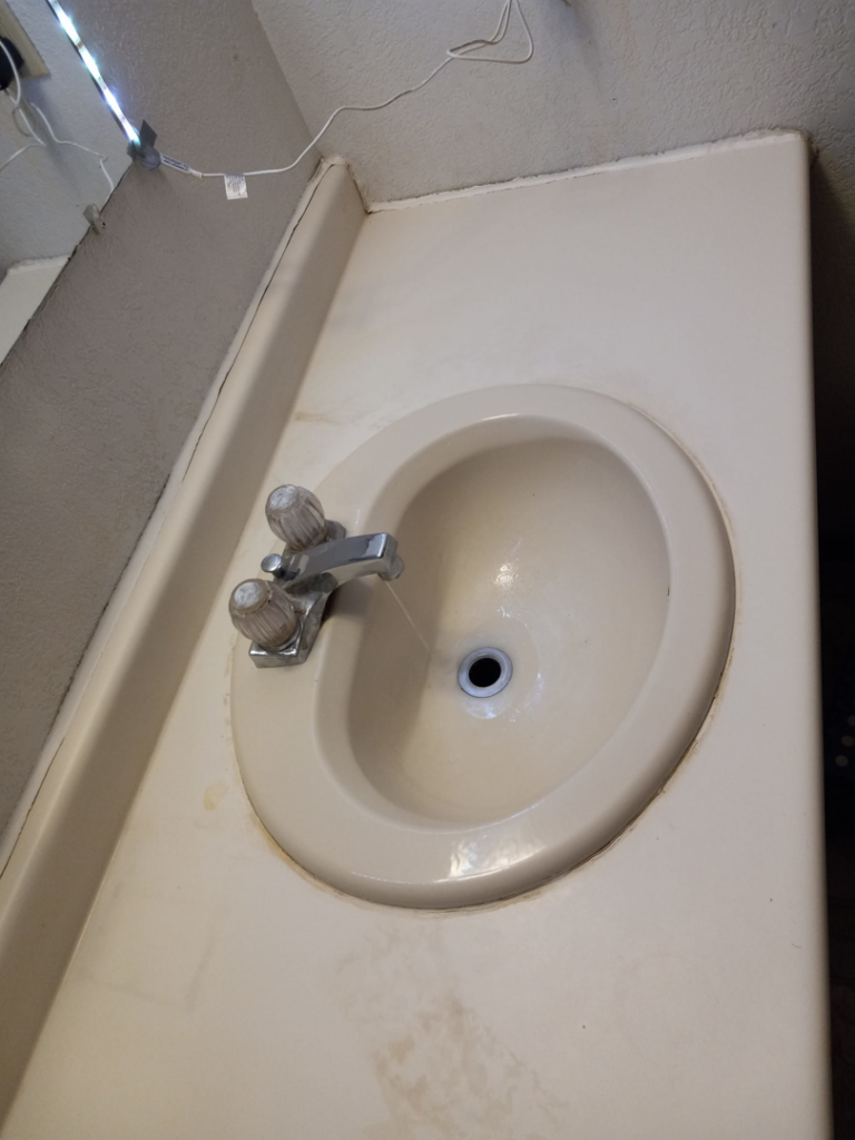 A dirty bathroom sink with visible stains, representing a 'before' cleaning state by J & A Cleaning and more in Norfolk, NE.