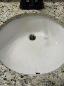 A dirty bathroom sink before cleaning by Lake Area Cleaning Services in Lake Charles, LA