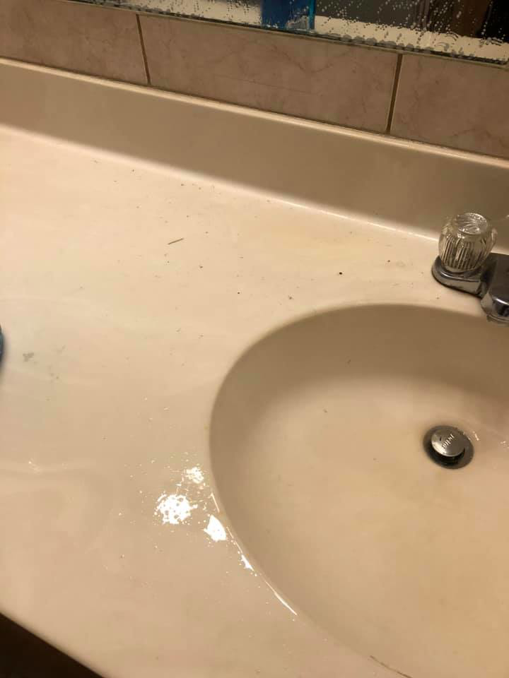 A dirty bathroom sink and countertop with visible dust and debris before cleaning by RA Cleaning Services in Brockton, MA.