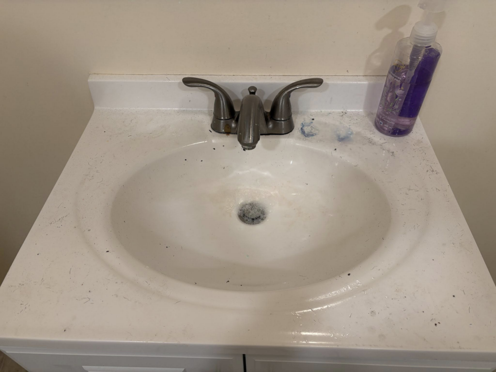 A dirty bathroom sink and countertop covered in grime before cleaning by Tri-State Clean Queen in Elsmere, KY.
