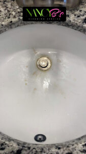 A dirty bathroom sink with visible stains before cleaning by Nancy B's Cleaning Service LLC in Atlanta, GA.