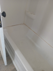 A dirty bathtub before cleaning, demonstrating the need for professional house cleaning by Dacari's Helping Hands LLC in South Bend, IN.