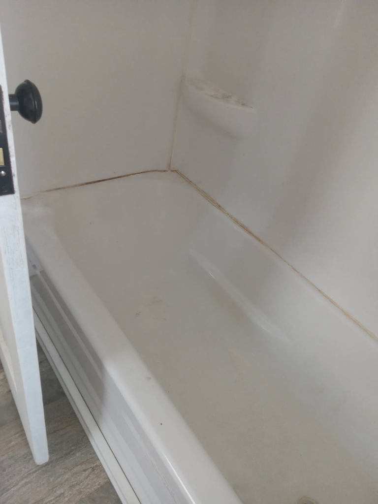 A dirty bathtub before cleaning, demonstrating the need for professional house cleaning by Dacari's Helping Hands LLC in South Bend, IN.