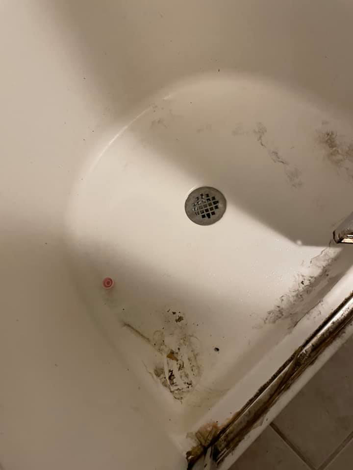 A dirty bathtub with visible grime and mildew, showing a 'before' state for Every Time Cleaning services in Cedar Rapids, IA.