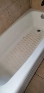 A dirty bathtub with visible grime and residue on the bottom, before cleaning by Jolley Services, INC in Bossier City, LA.
