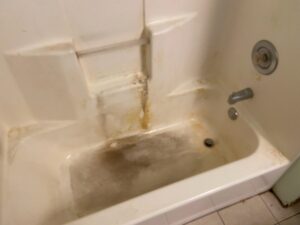A very dirty bathtub before professional cleaning by No Stress Cleaning Services in Virginia Beach, VA