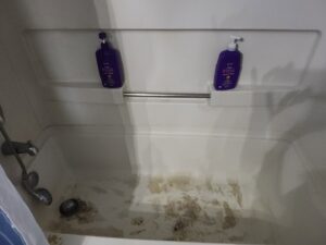 A very dirty bathtub before professional cleaning by No Stress Cleaning Services in Virginia Beach, VA