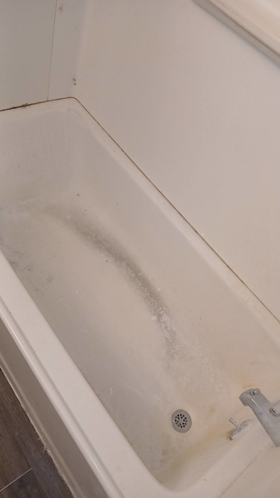 A dirty bathtub with visible grime and water stains, illustrating a typical cleaning challenge for On Point Cleaning Authority in Dayton, OH.