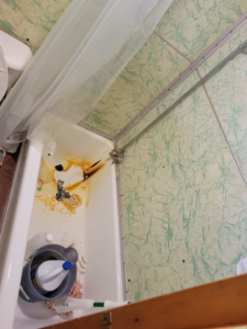 A very dirty bathtub with visible grime and cleaning supplies, before service by Rachel's Residential Cleaning in Chino Valley, AZ.
