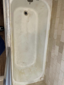 A dirty bathtub with visible grime, awaiting a professional cleaning service from Maid It Dirty Cleaning Company in Phoenix, AZ.