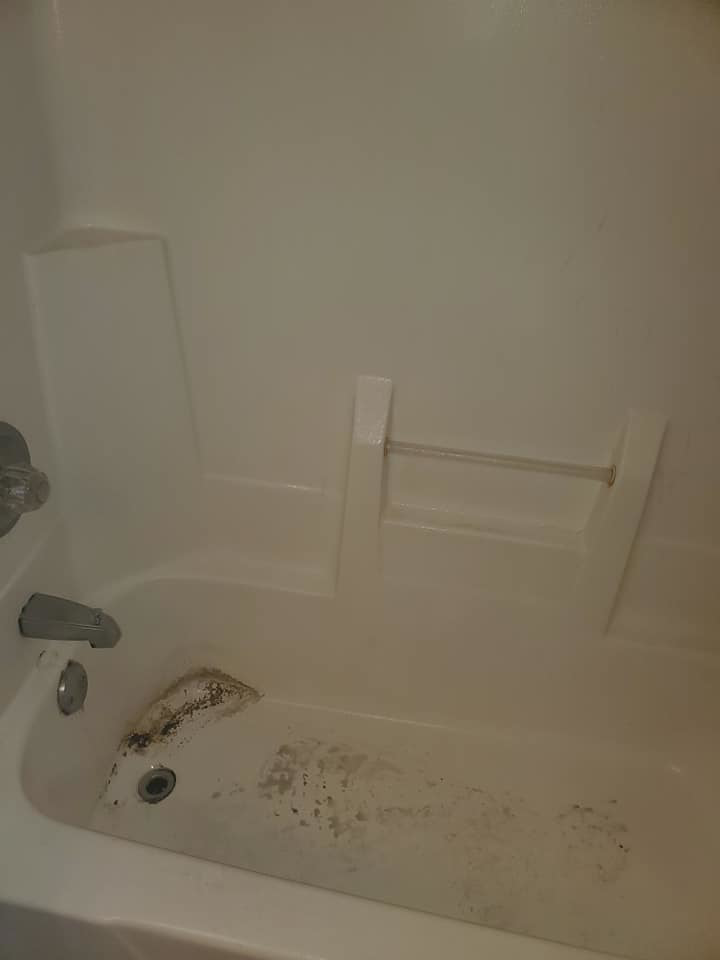 A dirty bathtub with grime and mold, showing the need for professional cleaning by Tip Top Cleaning in Champaign, IL.