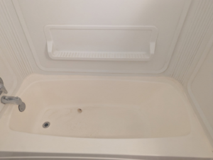 A dirty bathtub showing grime and residue before a professional cleaning service by The Cleaning Fairy in Fort Lauderdale, FL.