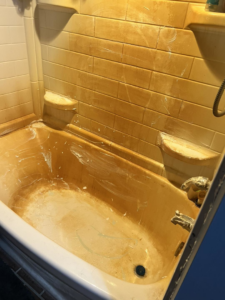 A very dirty and stained bathtub before professional cleaning by Treadway's Cleaning Services in Spencer, IN